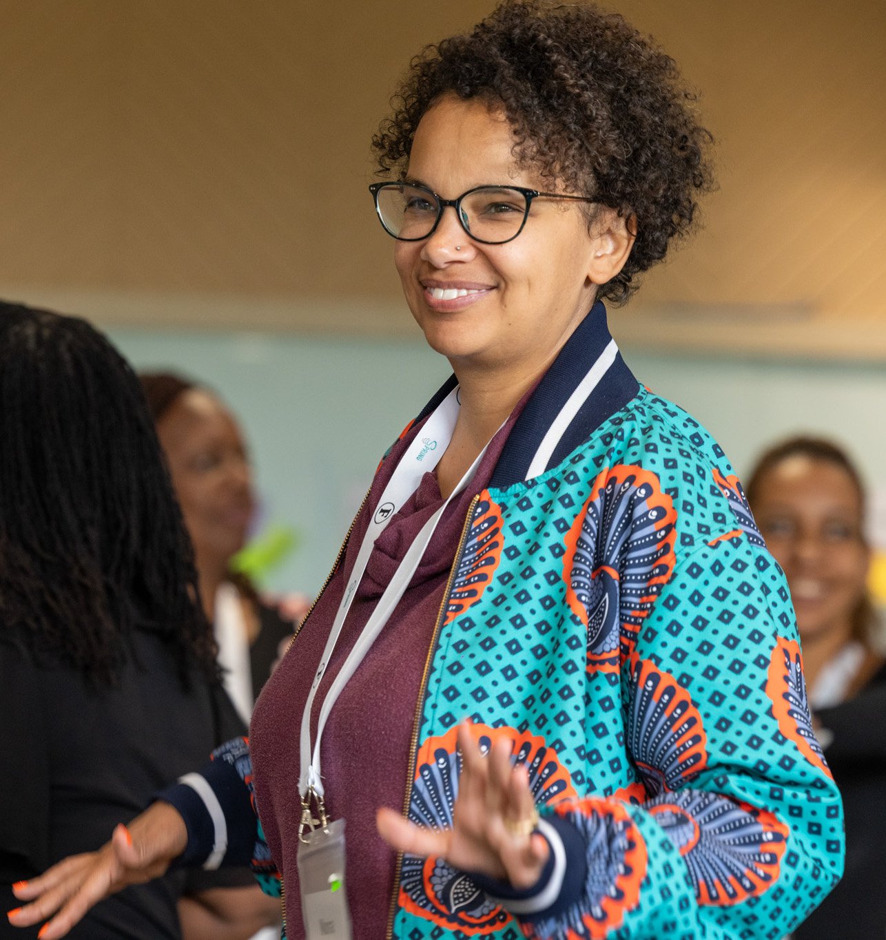 A woman smiling in a playful pose during an in-person training in Nairobi