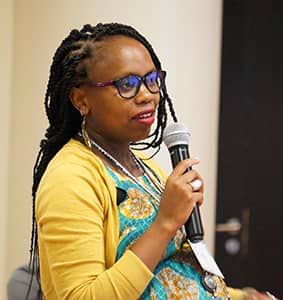 CollaborationWoman holding a microphone sharing her views in a calm and engaged manner in the Collaboration program