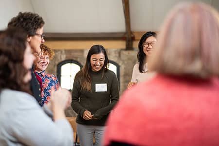 Circle of excited women actively participating in the dynamics of the Collaboration program