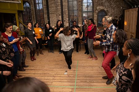 Group dance dynamics within a circle of people from the Collaboration program