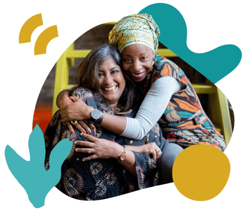 Two women hugging and creating effective collaboration