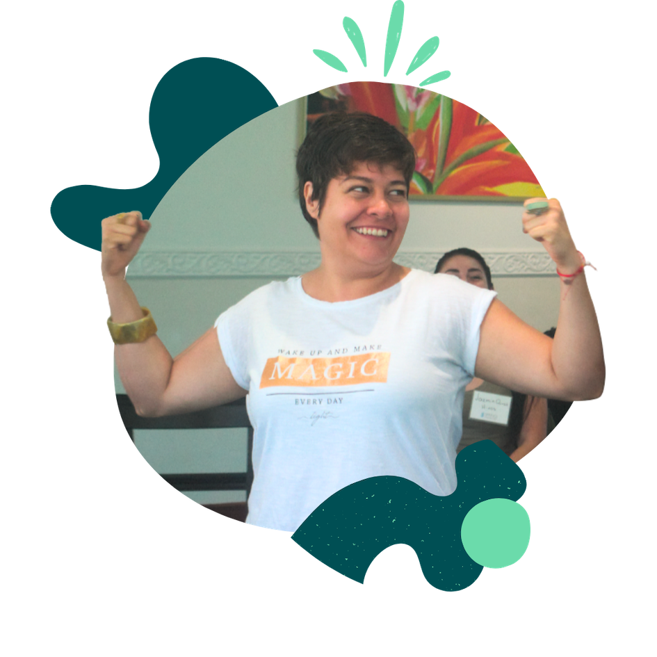 A woman smiles, flexing her biceps