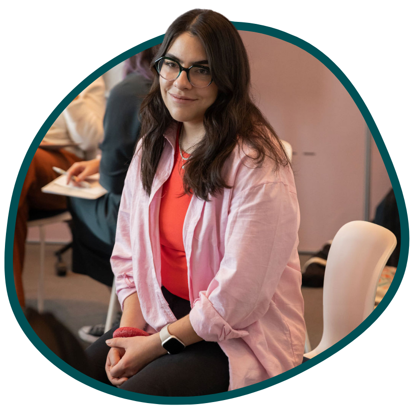 A woman sitting in the chair smiling to someone out of vision