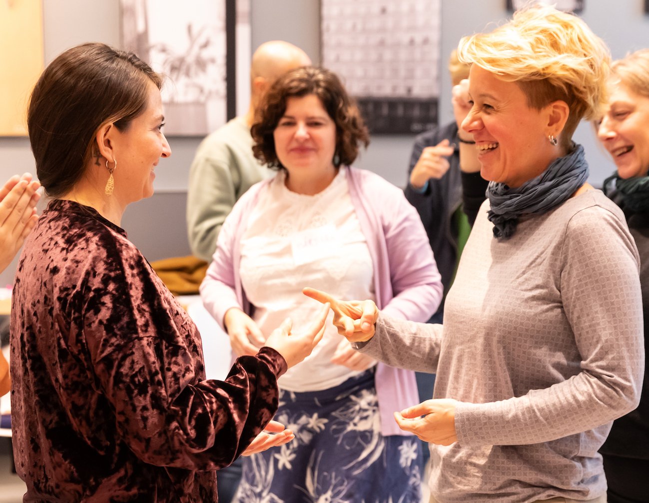 Three excited women actively participating in the dynamics of the Reimagining Collaboration program