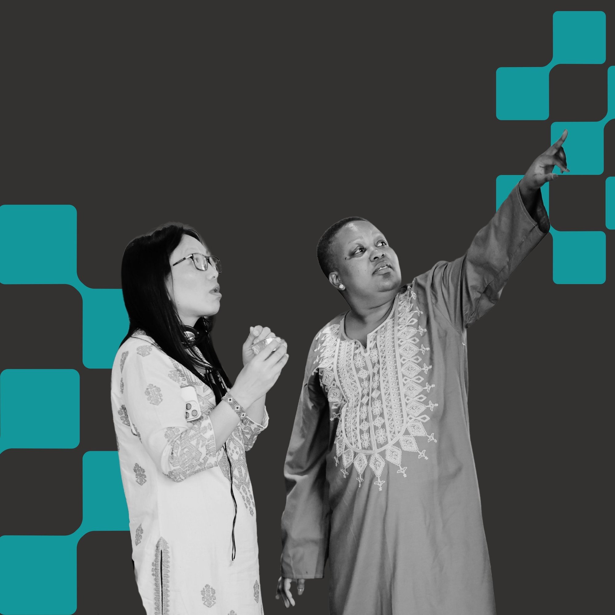 2 women pointing and looking at something to the right