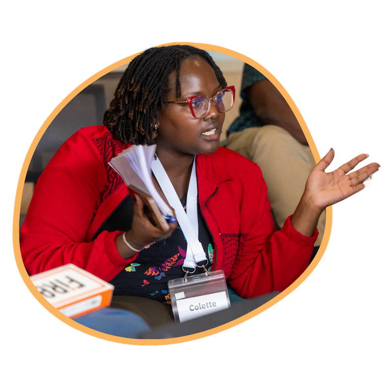 Lady in red jacket speaking to someone on her left