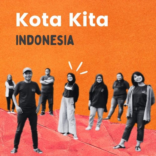 Kota Kita - Indonesia. The Kota Kita team, dressed in dark t-shirts smiles at the camera. Some women wear headscarves.