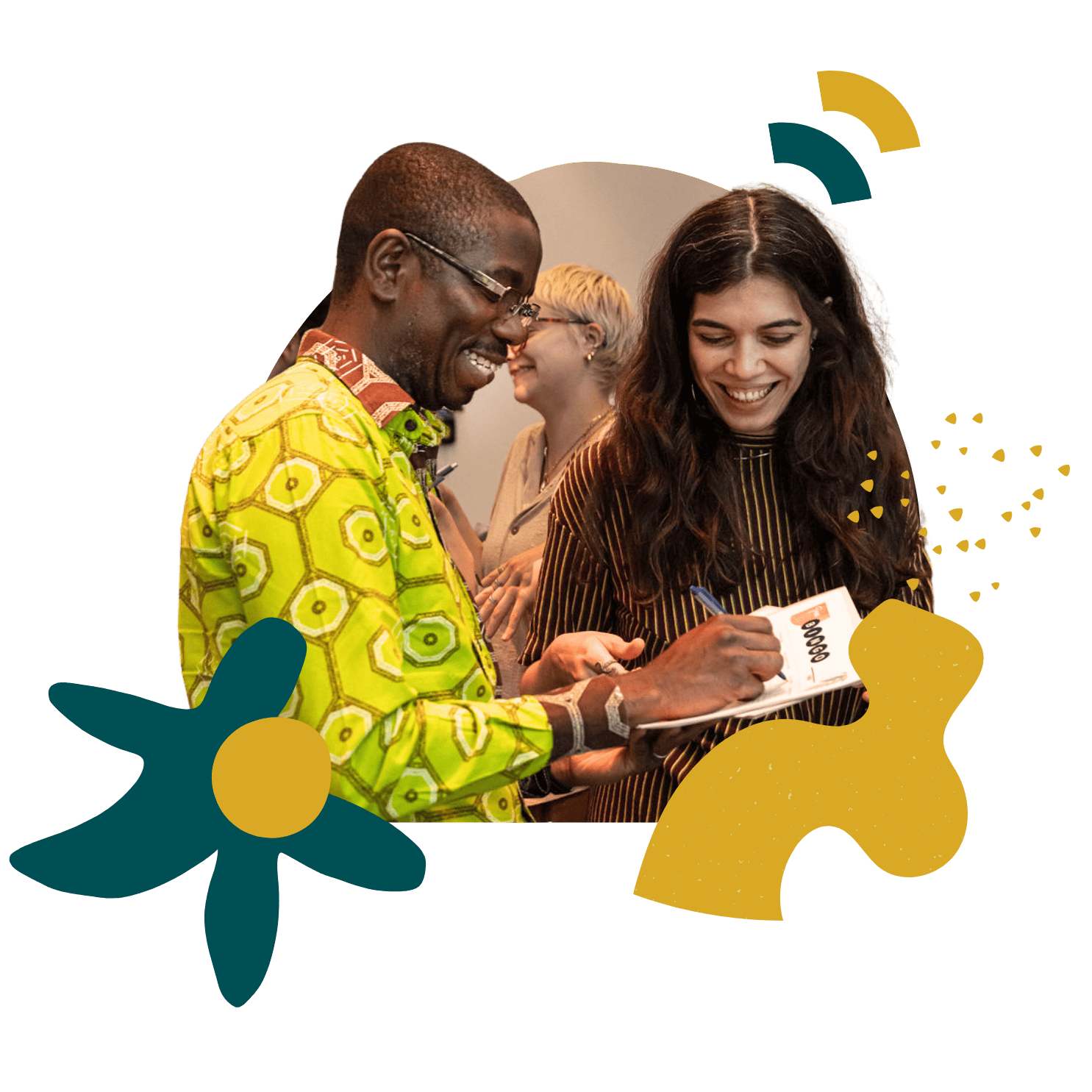 Two people stand next to each other smiling and writing on a piece of paper during a state shift exercise