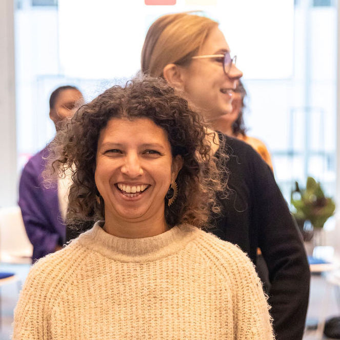 2 women stand in single file smiling during a state shift exercise